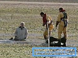 На фотографијата се прикажани спасувачите кои пристигнаа на помош на човек кој беше заглавен во жив песок.